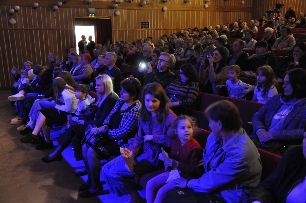 Sala widowiskowa. Publiczność. Pomieszczenie przyciemnione.